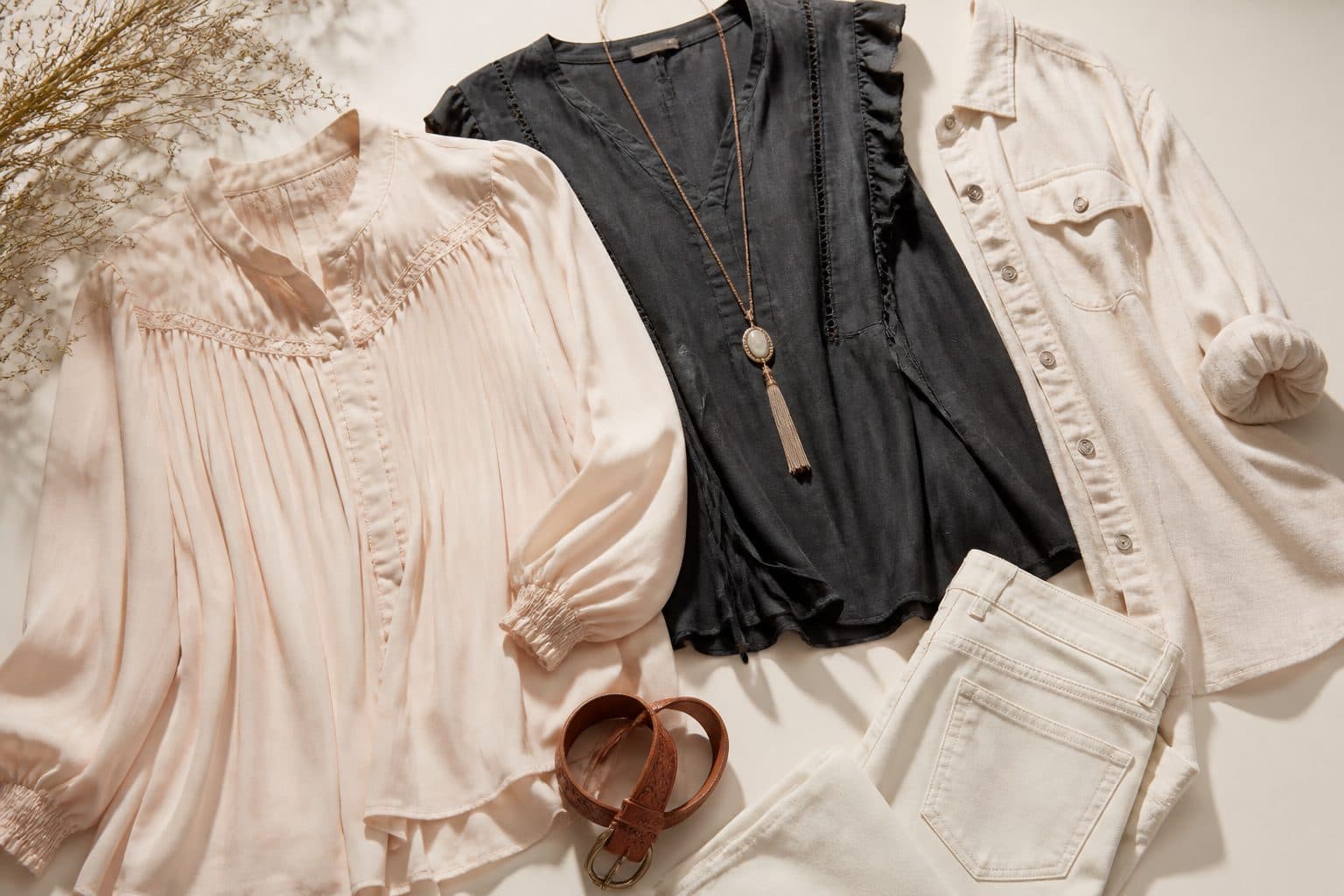 Boutique women's tops styled in a warm editorial flat lay